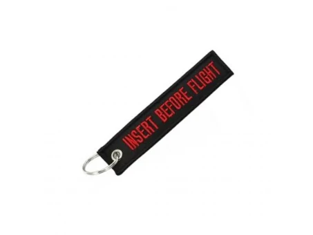 Breloc moto textil "iNSERT BEFORE FLIGHT"